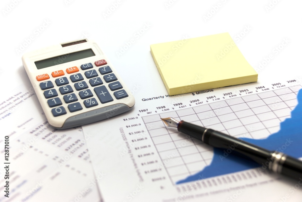 Business reports with calculator and fountain pen. Business reports with calculator and fountain pen.