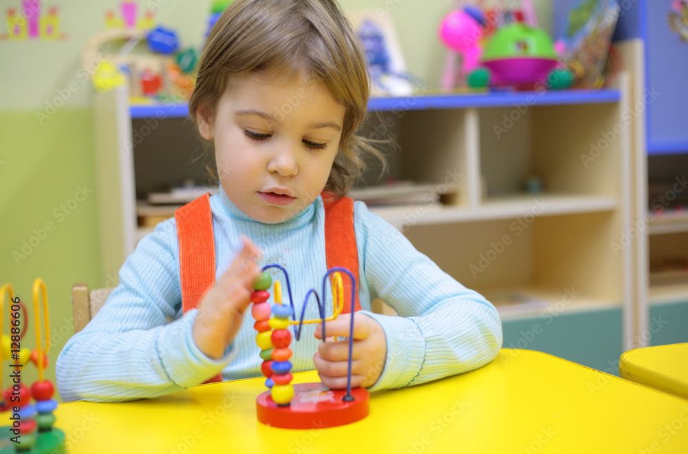 Little girl plays in kindergarten Little girl plays in kindergarten