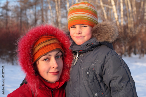 Mother with son in wood in winter