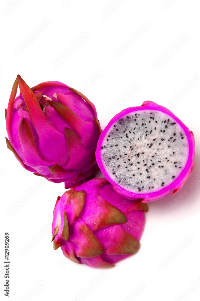 whole and two half of dragon fruit over white whole and two half of dragon fruit over white