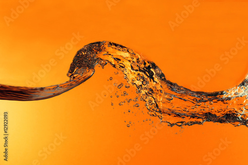 Isolated water wave against orange background