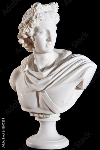 Classical marble white Apollo Bust isolated on black background