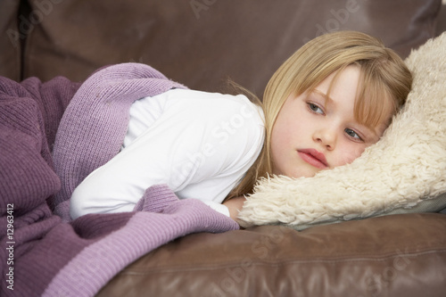 Young Girl Unwell Lying On Sofa