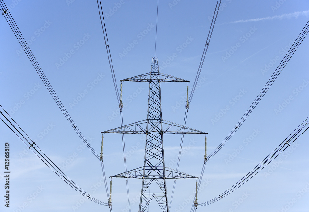 Electricity Pylons Against A Blue Sky Electricity Pylons Against A Blue Sky