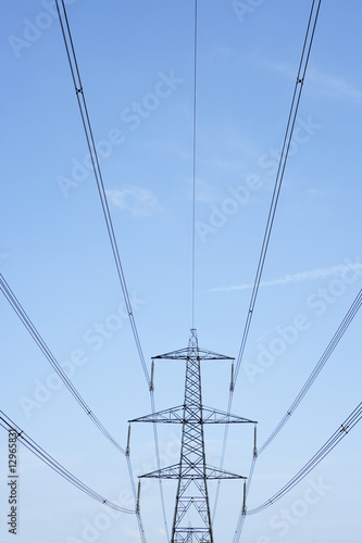 Electricity Pylons Against A Blue Sky