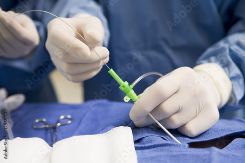 Obraz na płótnie Surgeon Inserting Tube Into Patient During Surgery