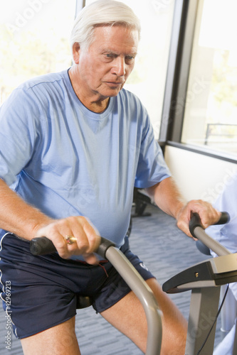 Patient Working Out On Exercise Machine