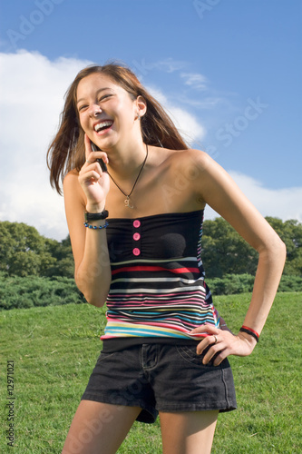Beautiful Girl Speaking Talking on the Mobile CellPhone Outdoors