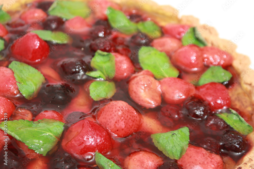 pie with ripe strawberry, blackberry and mint in over white back pie with ripe strawberry, blackberry and mint in over white back