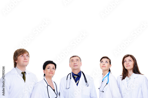 several medical doctors in hospital gown looking up