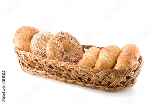 Bagels and croissants in a basket isolated