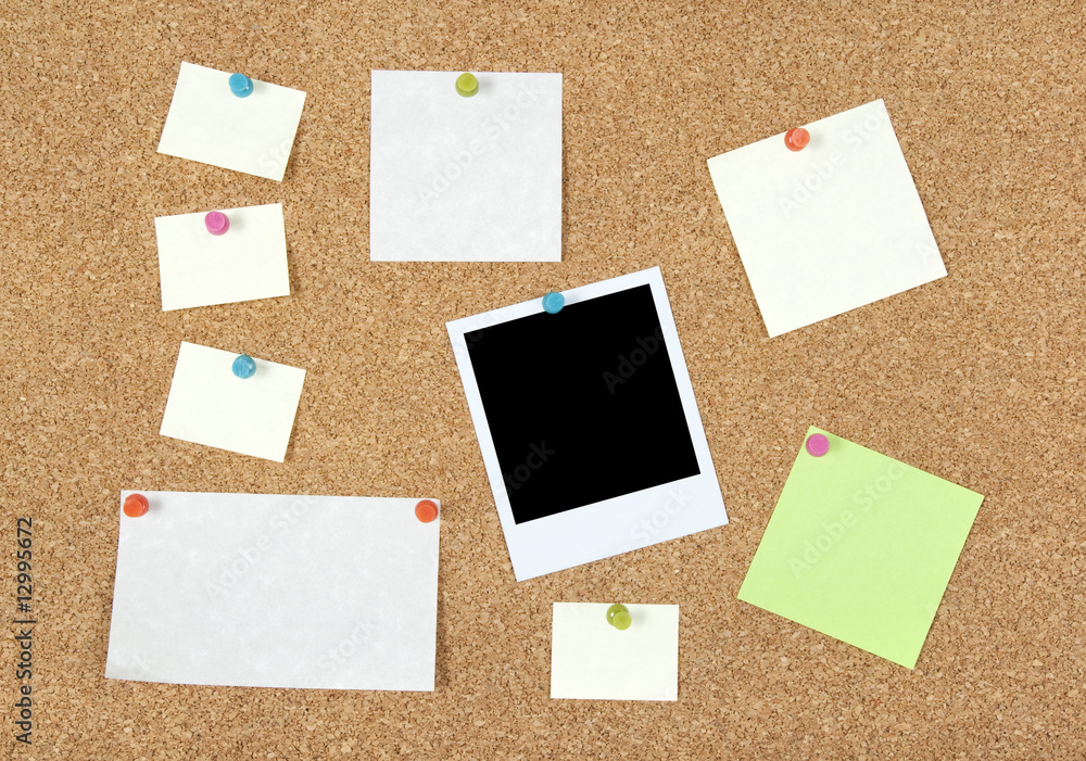 Post-it notes, papers and photo on a corkboard Post-it notes, papers and photo on a corkboard