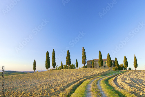 a typical Tuscan landscape in Italy with a Tuscan villa