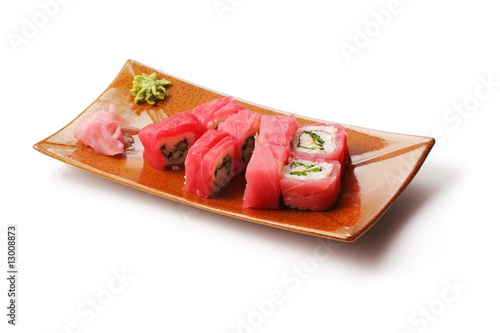 Rolls with tuna, crabmeat and onion in brown squared plate