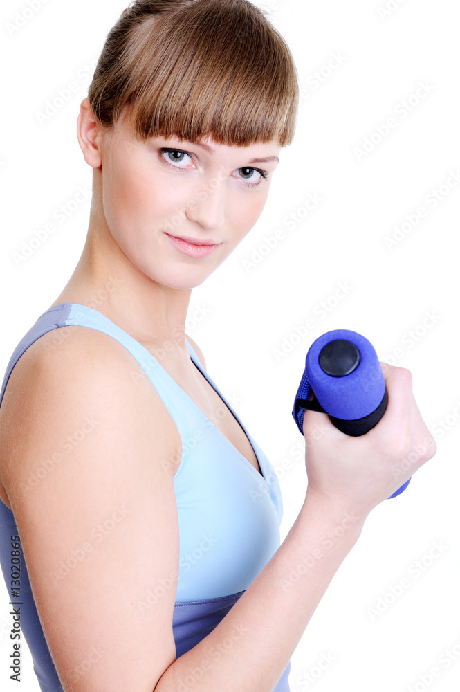beautiful young girl with dumbbell looking at camera