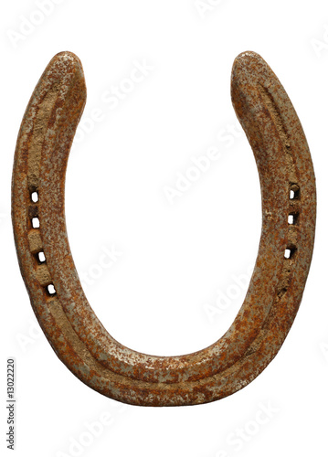 Old rusty lucky horseshoe isolated on a white background.