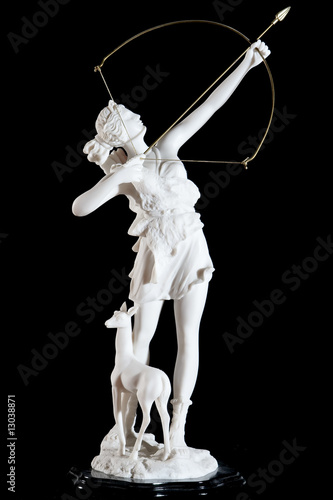 Classic white marble statuette of Artemis isolated on black photo