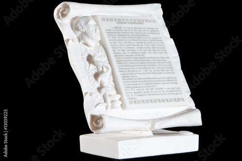 Classical white marble Hippocratic Oath isolated on black photo