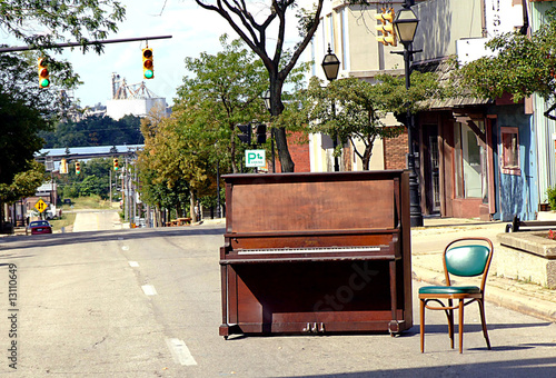 Abandoned Piano and Green Chair in the middle of the street