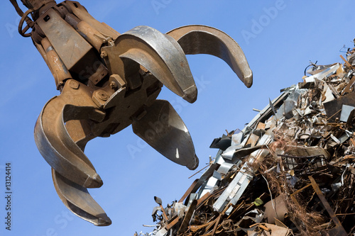 crane grabber up on the rusty metal heap photo