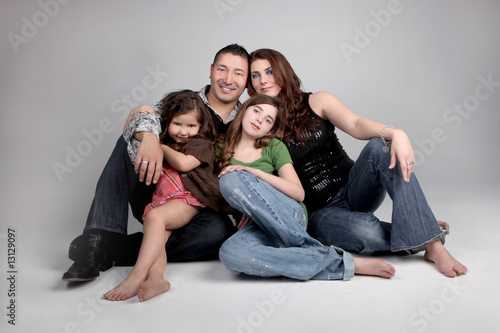 Portriat of Siblings and Their Parents on Grey Background
