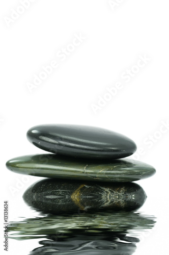 Spa stones on white background with water reflection