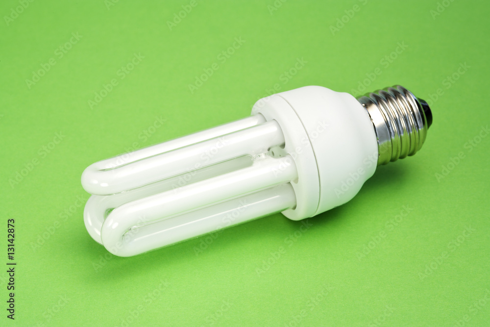 energy saving light bulb on green surface energy saving light bulb on green surface