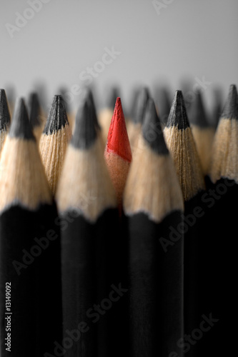 A bunch of graphite pencils with one red in the middle