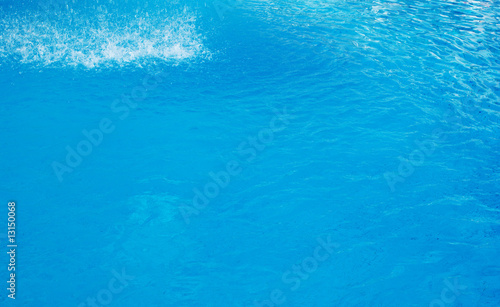 blue background with sun reflected in the swimming-pool water