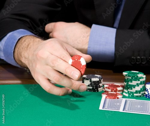 Hand with casino chip