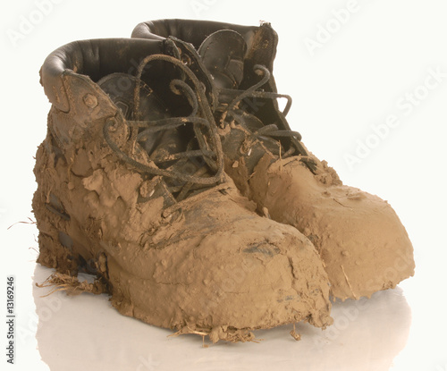 muddy work boot isolated on a white background photo