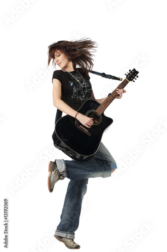 Teenager girl playing an acoustic guitar, isolated on white