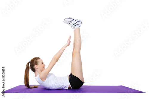 young female doing physical exercises on the floor