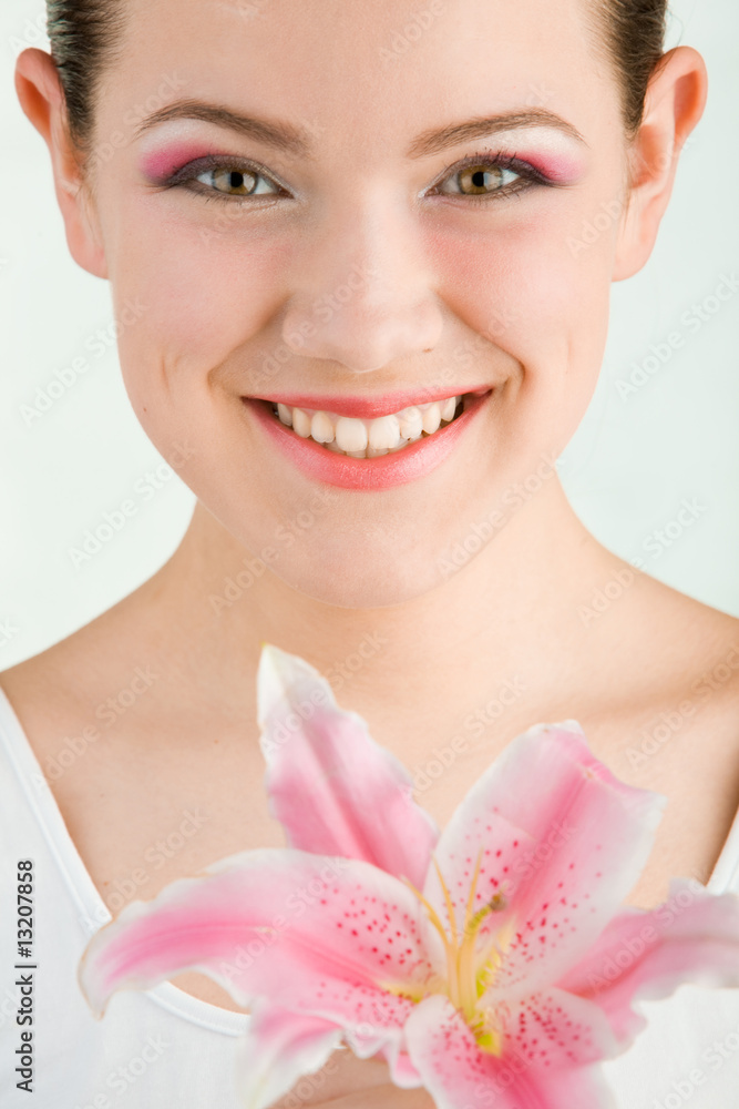 Portrait of Fresh and Beautiful girl with flower. Focus on eyes Portrait of Fresh and Beautiful girl with flower. Focus on eyes