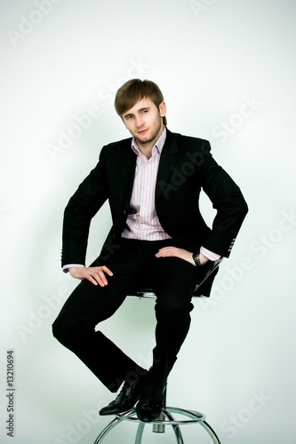 man in suite sitting on chair