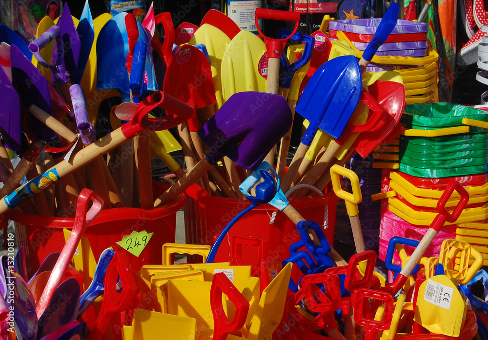 Obraz premium Colourful Childrens Buckets and spades display at the seaside