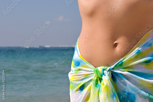 Woman belly and ocean