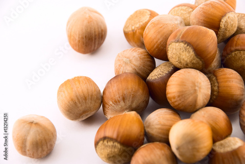 a pile of hazelnut on white background