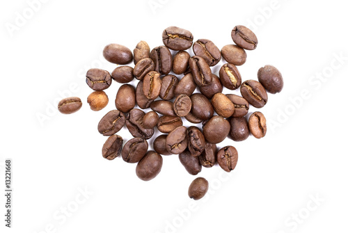 Heap of brown roasted coffee beans isolated on white background.