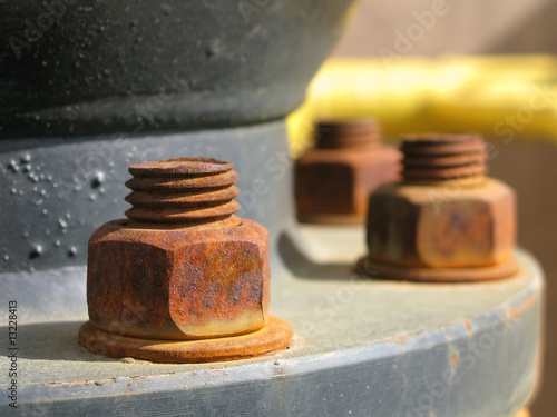 Old rusty metal nut on iron water valve