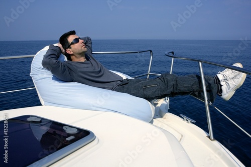 Man on bow boat relaxed on bean bag © lunamarina