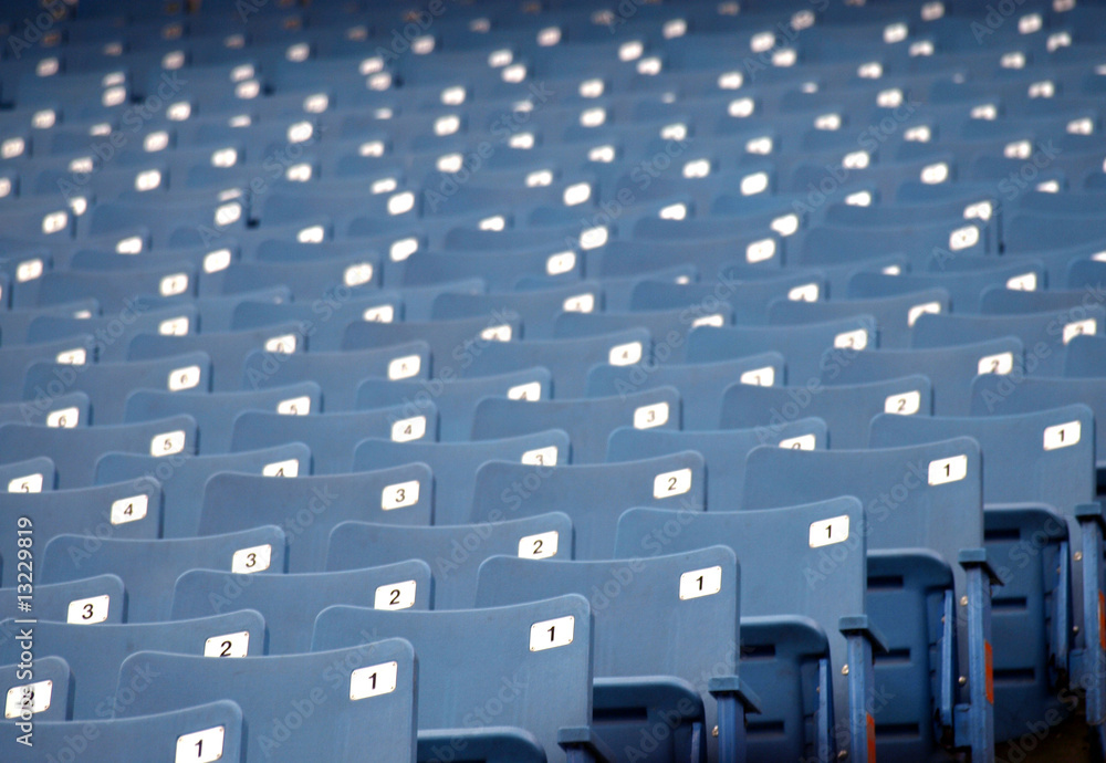 Row of blue empty seats at a sports arena Row of blue empty seats at a sports arena