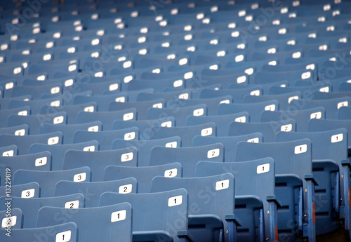 Row of blue empty seats at a sports arena