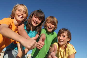 group of happy tweens at summer camp thumbs up