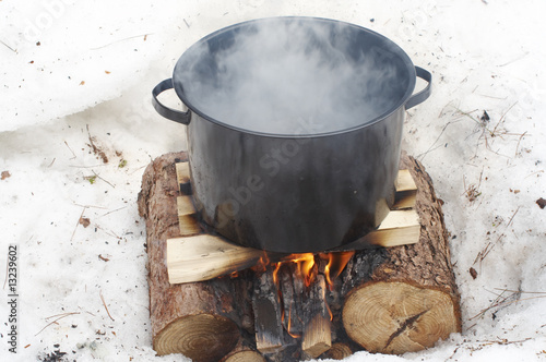 a pot maple sap boiling on a open fire