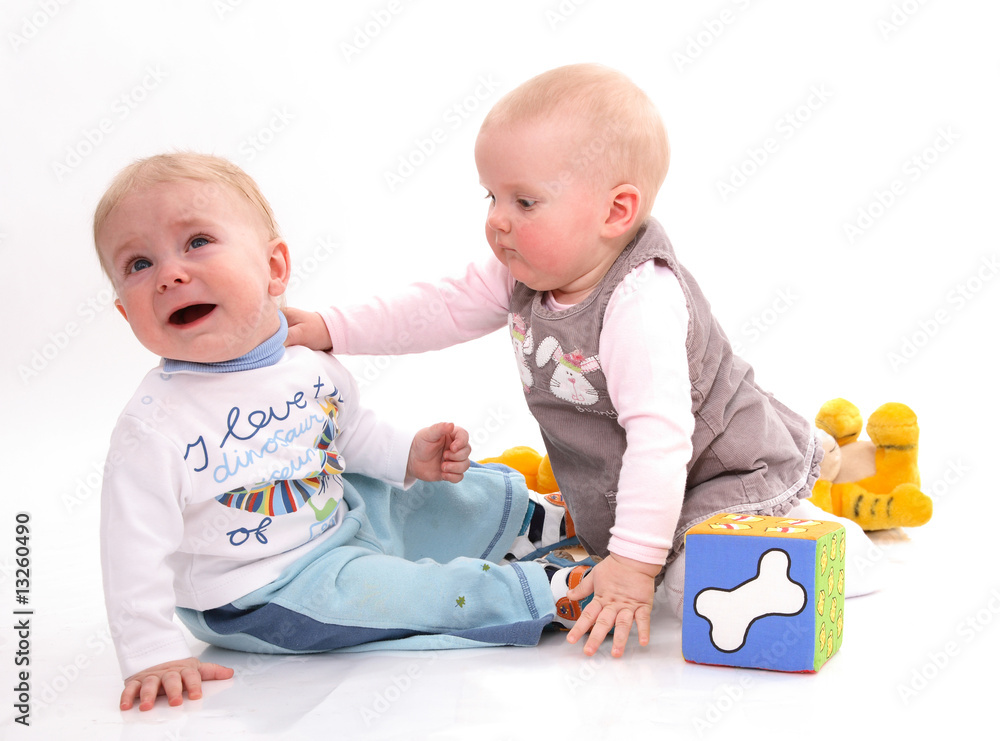 The little girl calms the crying little boy The little girl calms the crying little boy