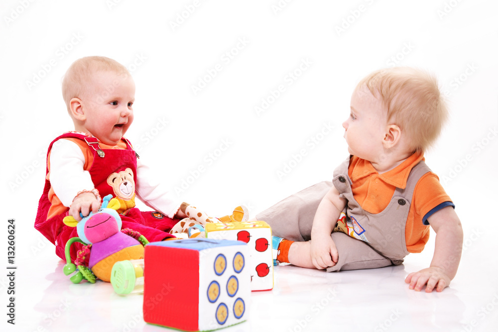 Small boy and the girl sit among toys Small boy and the girl sit among toys