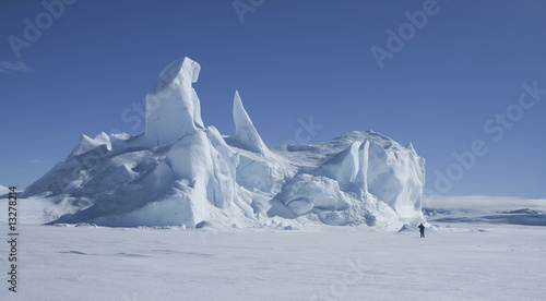 Iceberg frozen in the sea ice photo