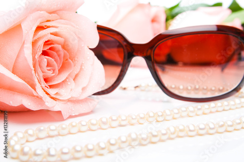 Pink rose, necklace and sunglasses photo