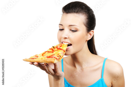 woman eating  piece of pizza